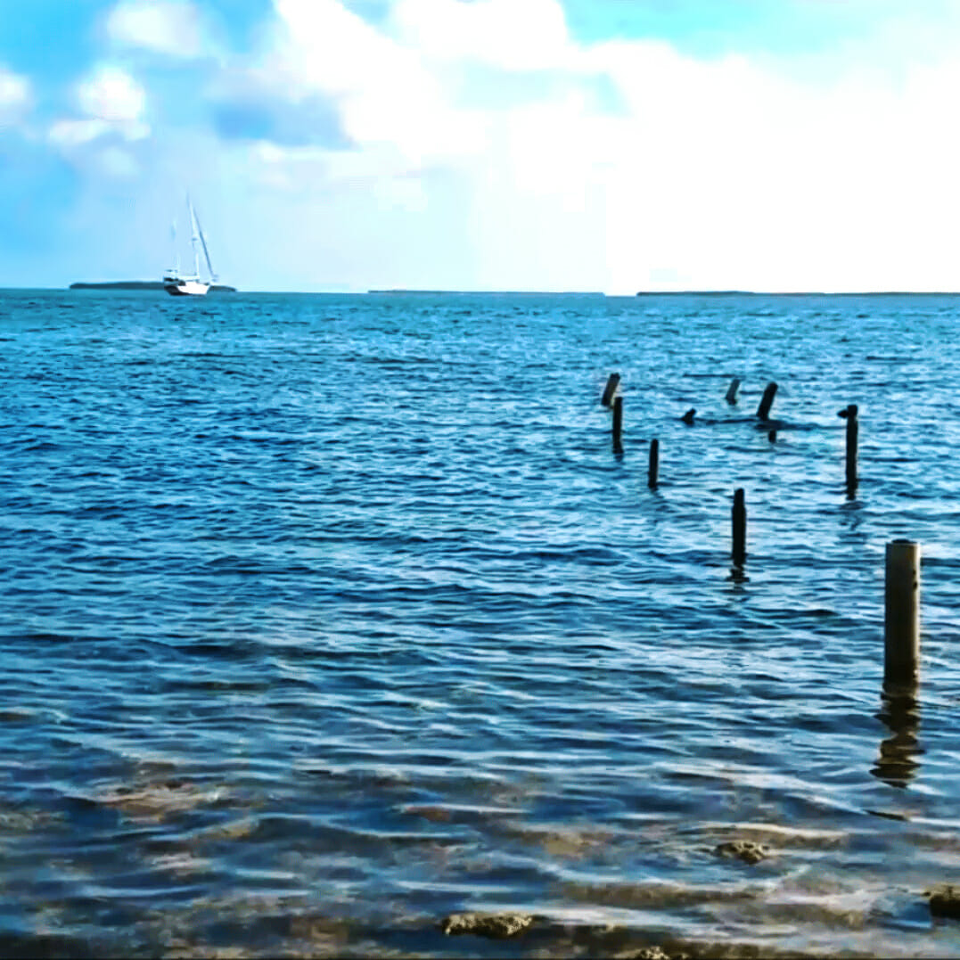 Key West NAS Sigsbee rocky shore and sailboat