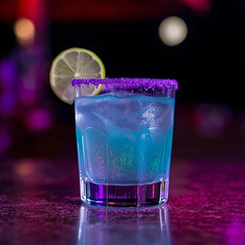 Mermaid Witches Brew Gin Cocktail with iridescent purple luster dust